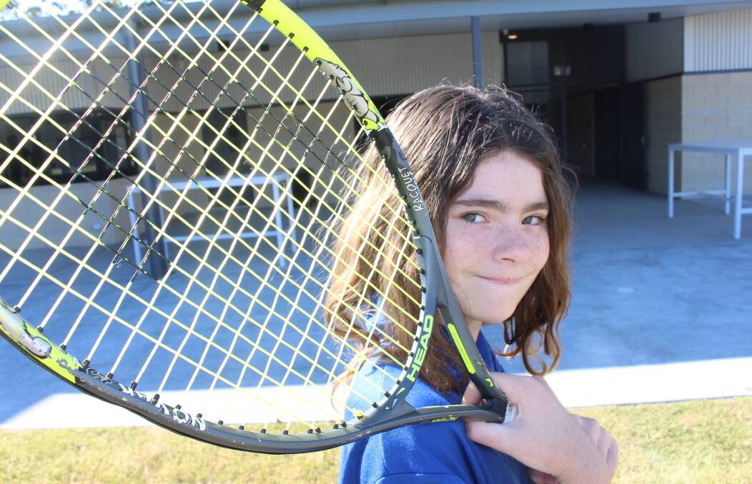 BIG SWING: Faith Lutheran college student Aurora Saltmarsh with her new pride and joy - world number one tennis player Ash Barty's racquet. Photo: Jordan Crick
