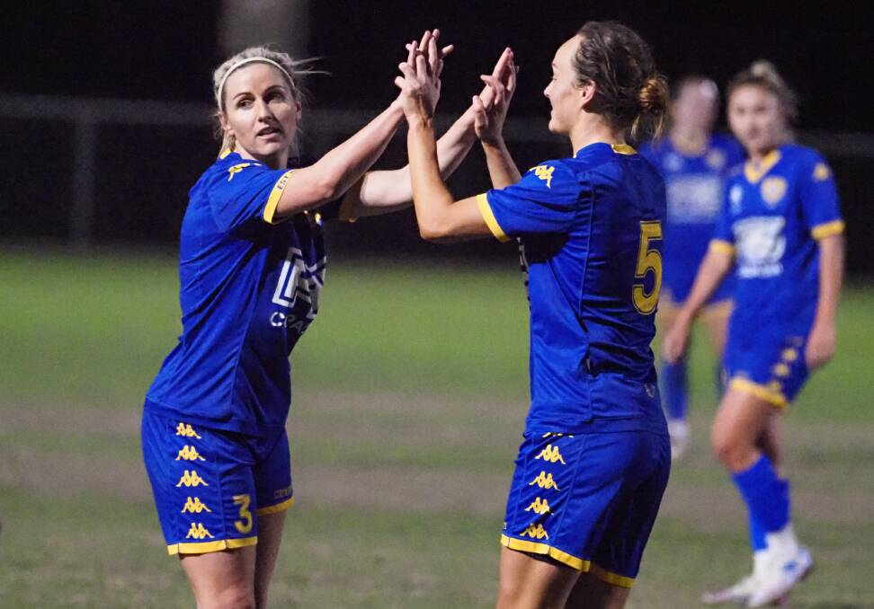 ALL SMILES: Amy Chapman and Amber Simms celebrate during their clash against Peninsula Power. Photo: Alan Minifie/Capalaba FC