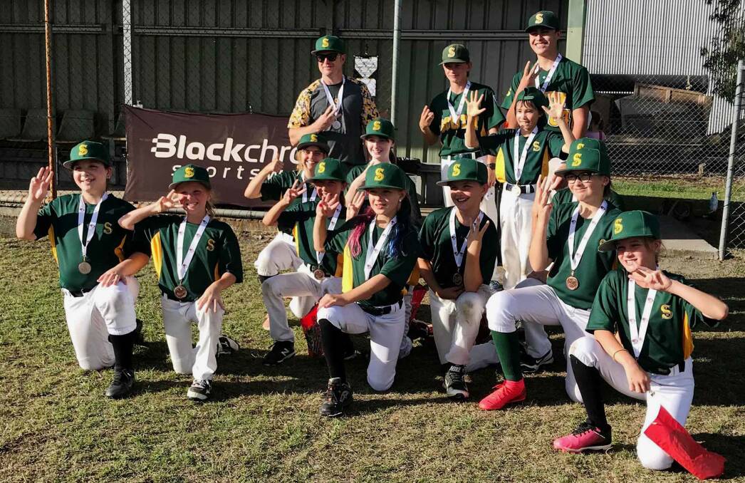 WELL PLAYED: The Brisbane South Little League girls celebrate after receiving a bronze medal. 