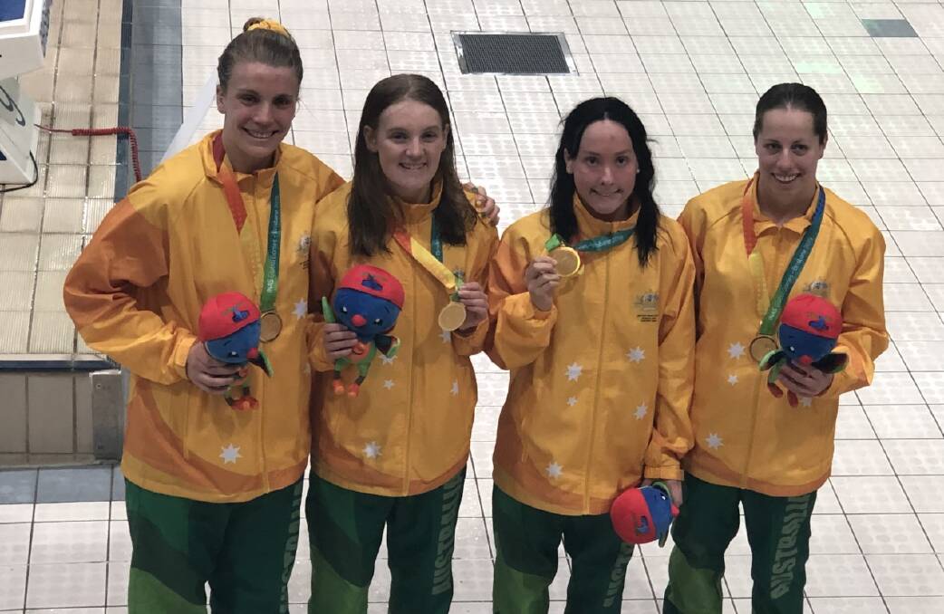 GOLD: PAIGE Leonhardt proudly parading her gold medal alongside her Australian teammates. 