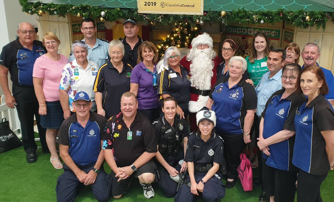 CHRISTMAS SPIRIT: Santa travelled all the way from the north pole to join Crimestoppers volunteers, police and Rotarians at Capalaba Central Shopping Centre. 