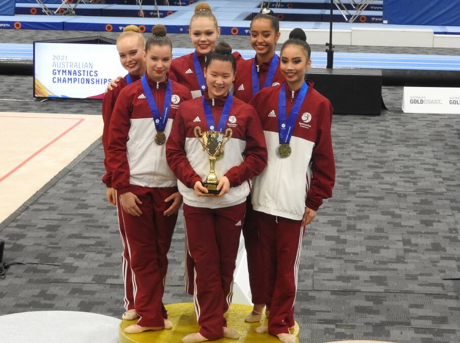 YOUNG STARS: Aileen Chiang, centre, celebrates with her teammates at the Australian Gymnastics Championships on the Gold Coast.