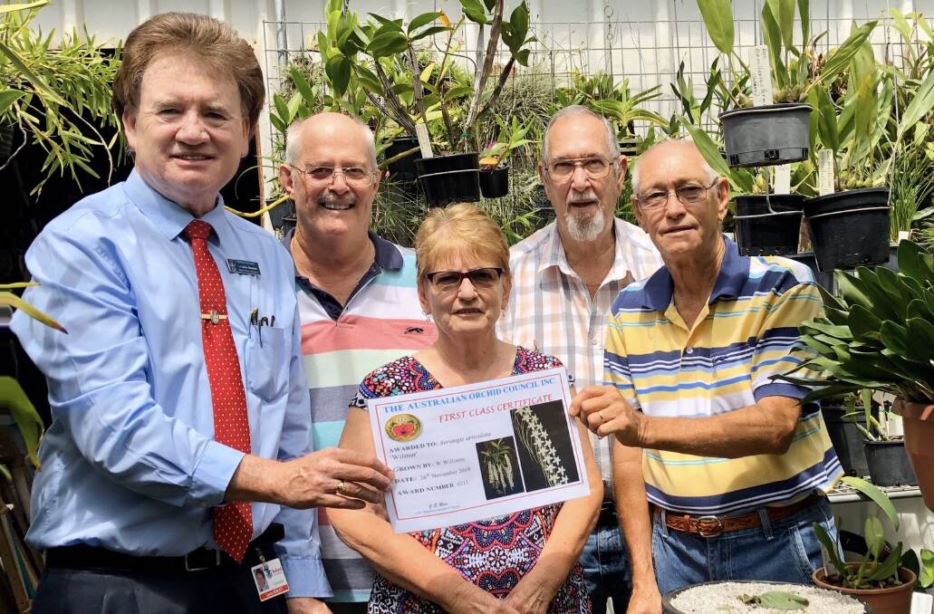 PLANT HEAVEN: Bill Williams receives his certificate from Cr Lance Hewlett. He will share his expertise at the Redlands Orchid Society's autumn show. 
