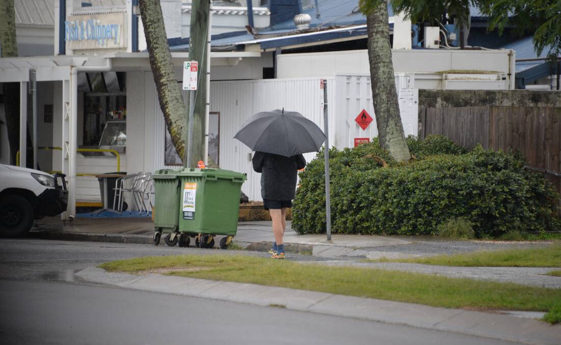 GLOOMY DAY: Brollies were out at Cleveland on Friday as the Redlands received decent rain. Photo: Jordan Crick