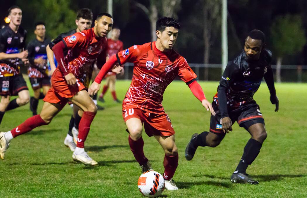 Ryo Emoto drives forward for Redlands United in Saturdays clash against Caboolture FC. Photo by Ray Gardner