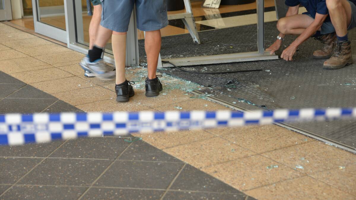 OBLITERATED: Shattered glass from the shop windows at one of the main entrances. Photo: Jordan Crick. 