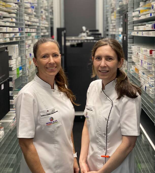 TECHNOLOGY UPGRADE: Sisters Shona Volker and Fiona Watson with the robot at Redland Bay WholeLife Pharmacy and Healthfoods. Photo: supplied