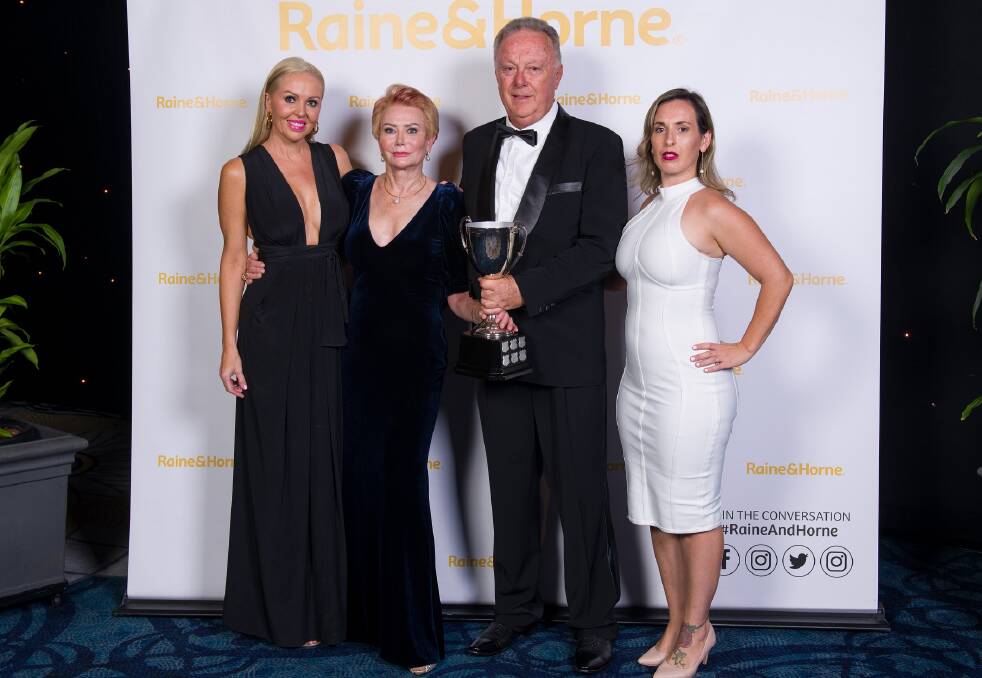 WINNERS: Michelle West, Jan Goetze, David Paterson and Shanna Dale from Cleveland's Raine and Horne office pose with their trophy at the company's awards ceremony. Photo: supplied