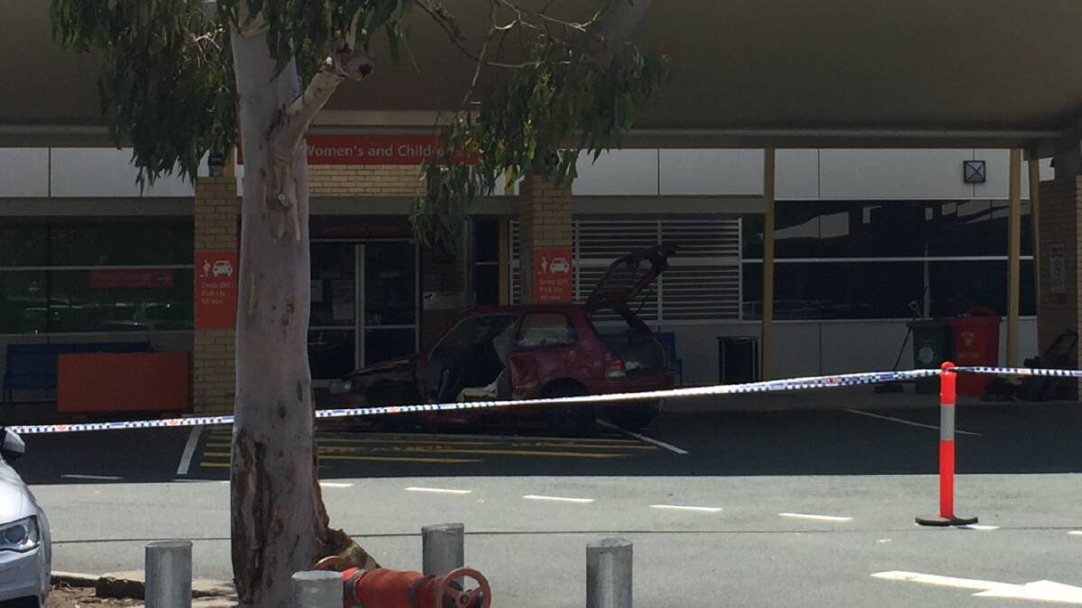 CRASH: The damaged car outside the women's and children's ward at Redland Hospital. 