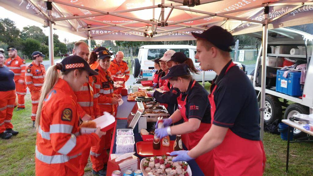 FOOD: Rapid Relief Team volunteers serve lunch to the SES during a Stradbroke Island training day. 