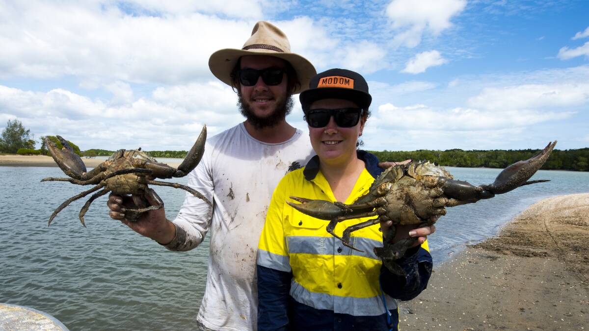 A GOOD FEED: Jack Sanker and Taylor Waghorn with their hands full of early season mud crabs. Rain has seen a few caught on the run-out tide.