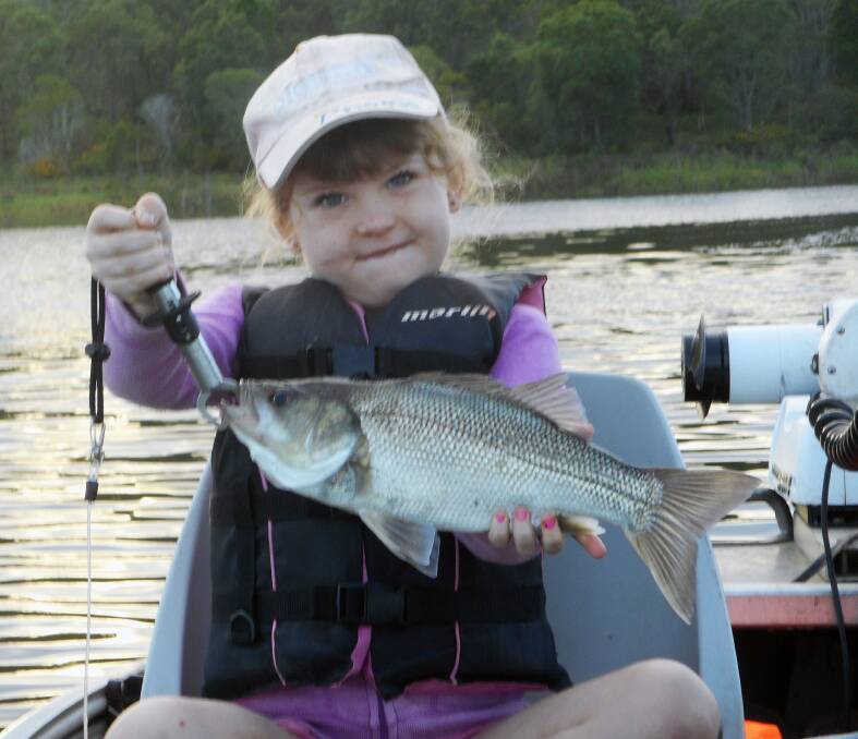 STARTING YOUNG: Phoebe Sutton happy with her bass from North Pine Dam. The dam is producing good numbers of bass and yellowbelly on both live shrimp and lures.