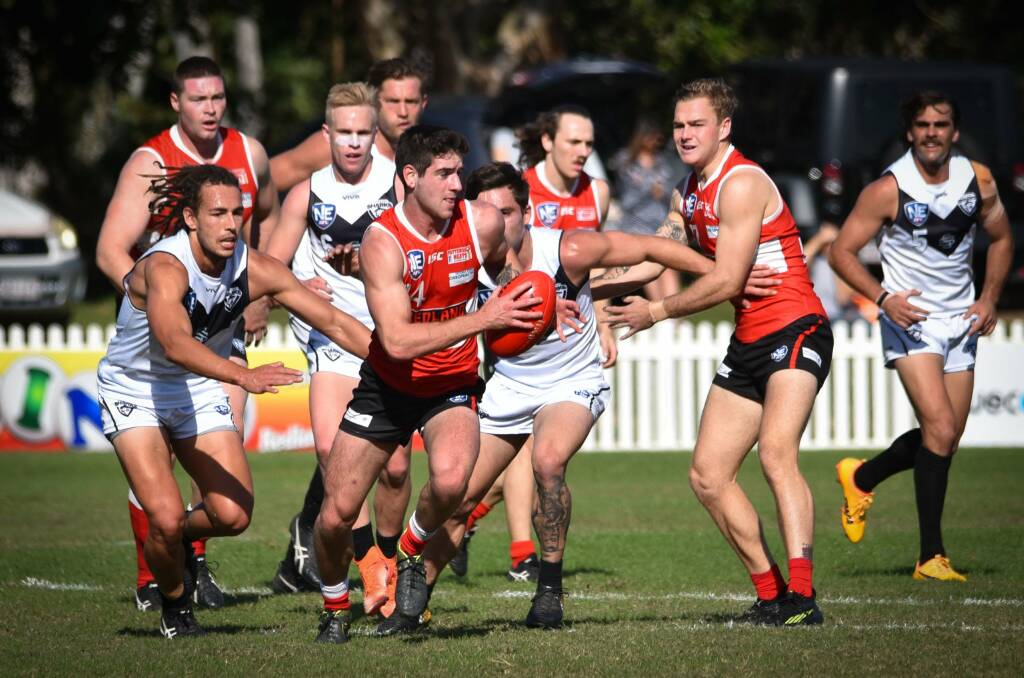 MAKING A BREAK: Bombers players fend off the Southport defence to make a break in their NEAFL match on Saturday. Picture: Highflyer Images.