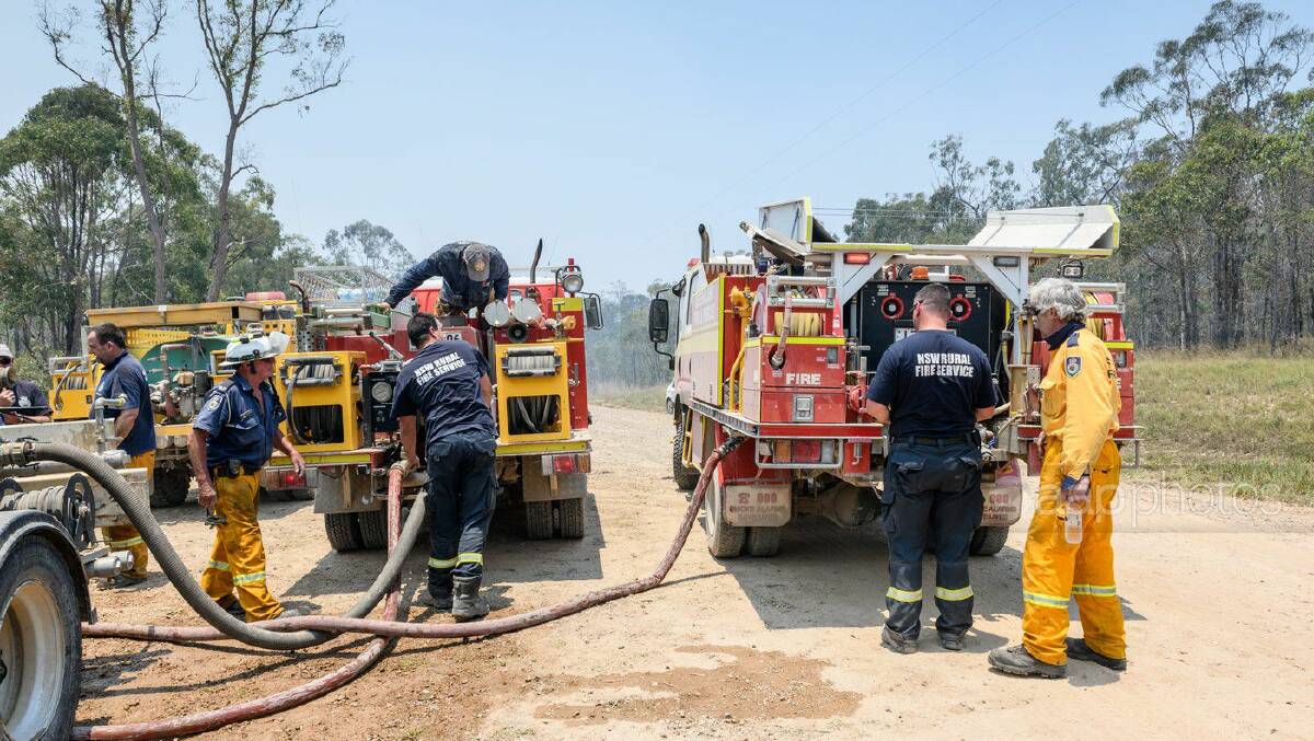 Rural fire fighters refill their fire trucks
