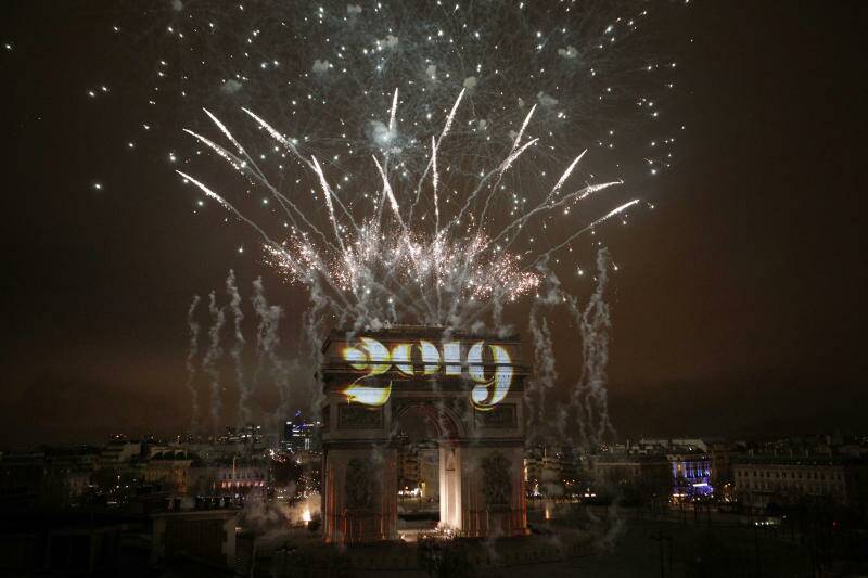 Fireworks explode over the Arc de Triomphe during the New Year's Day celebrations.