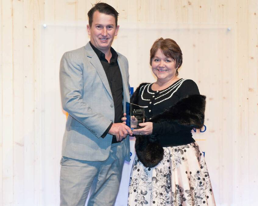 RECOGNITION: Director of Munro Designed Homes Chris Munro receives his award for Individual Homes ($651,000-$750,000) from Kim Sharpe.