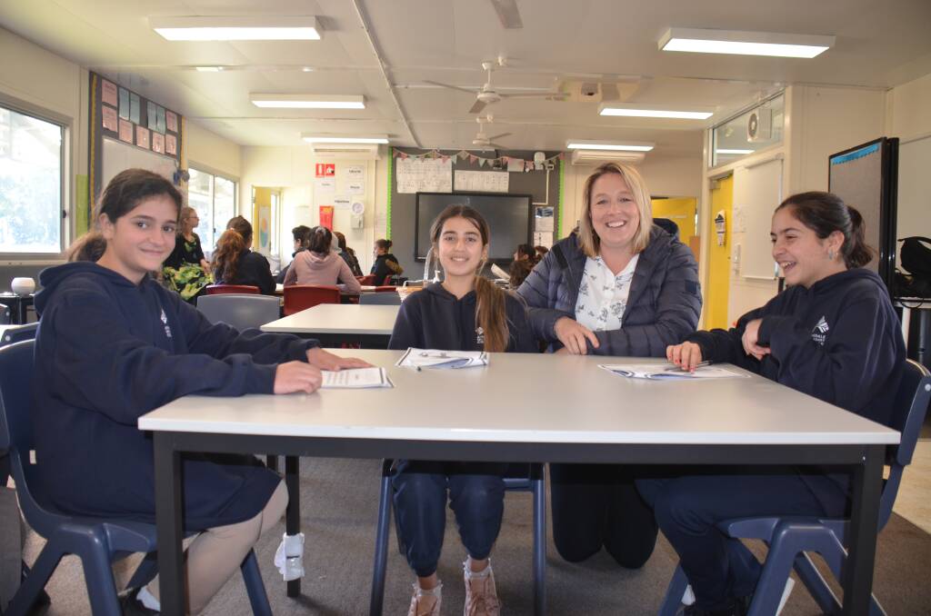 LEARNING ENGLISH: Warjin Al-khalaf, Zhiyan Murad and Neveen Elias with teacher Sarah Mills in the English classes at Armidale Secondary School. Picture: Laurie Bullock