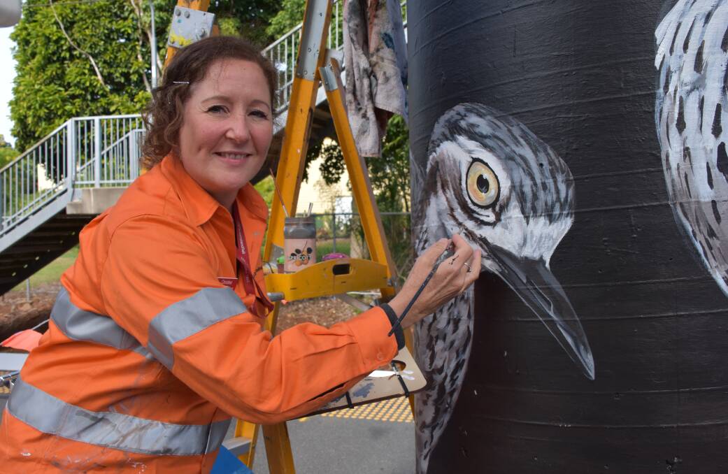 ON TRACK: Wellington Point station master Christina Gardner paints the curlews on platform 2.
