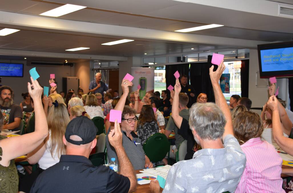 HANDS UP: People at the Redland Youth Justice and ICE Forum voiced their agreement or disagreement at the meeting by holding up pink or green tickets.