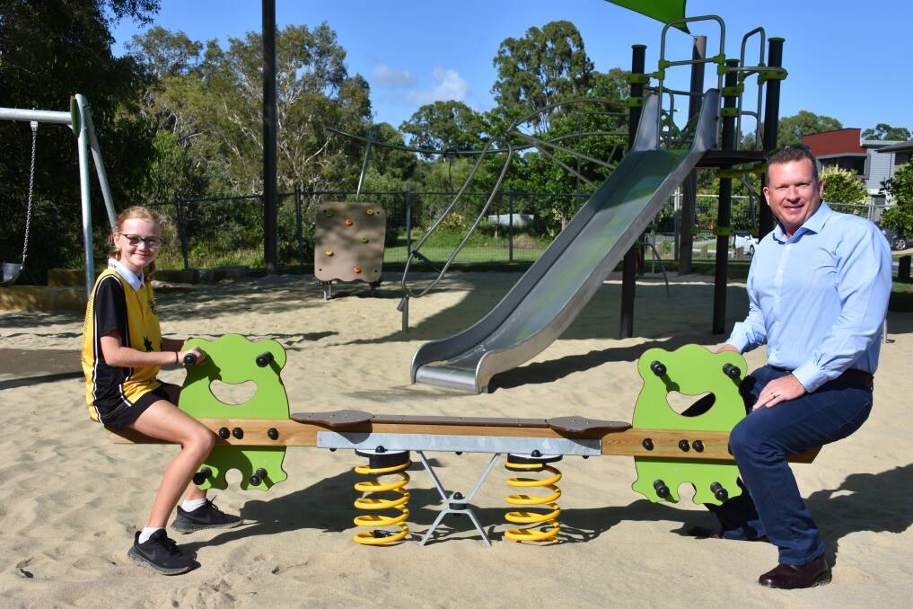 SEESAW: Molly Redgwell introduces Cr Paul Golle to the seesaw in the new park on Sandalwood Street, Thornlands.