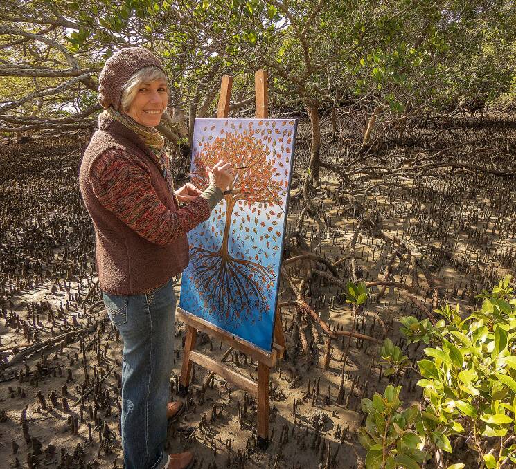 FOREST FRIENDS: Coochiemudlo artist Merrett Keech at work in the mangrove forest.