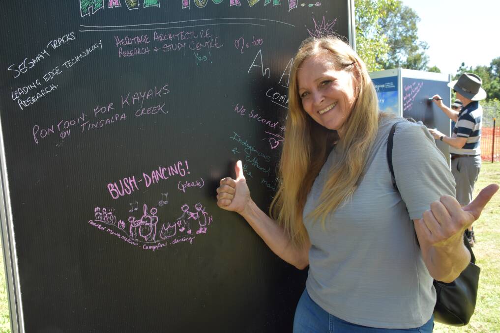 HAVE YOUR SAY: Leanne Allen from Birkdale gives bush dancing the thumbs up at the Dotmocracy stand at the Birkdale Community Precinct open day on Friday.