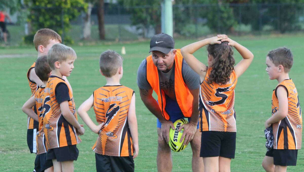 Tiger Shark coach Nathan Smith with his charges Dylan McLuckie, Darcy Burgess, Mackenzie Carothers, Jay Glewis-Smith, Ashley Kingston and Joshua Horn.