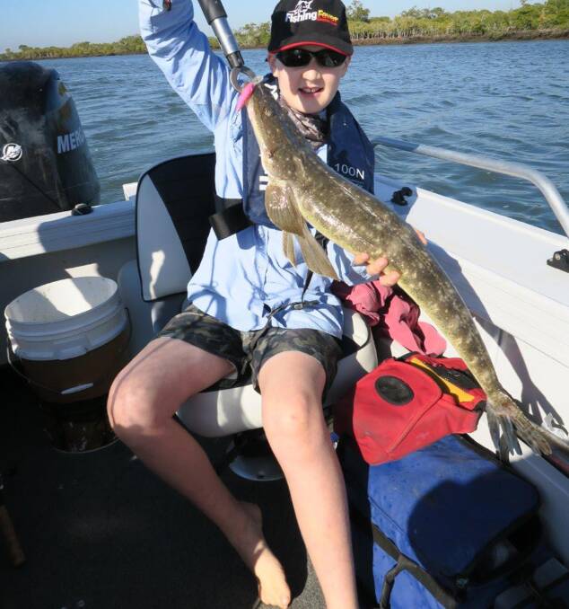 Reeled him in: Eight-year-old Maxwell Boothey was pleased to land a 69cm flathead near Jumpinpin recently. Photo: Supplied 