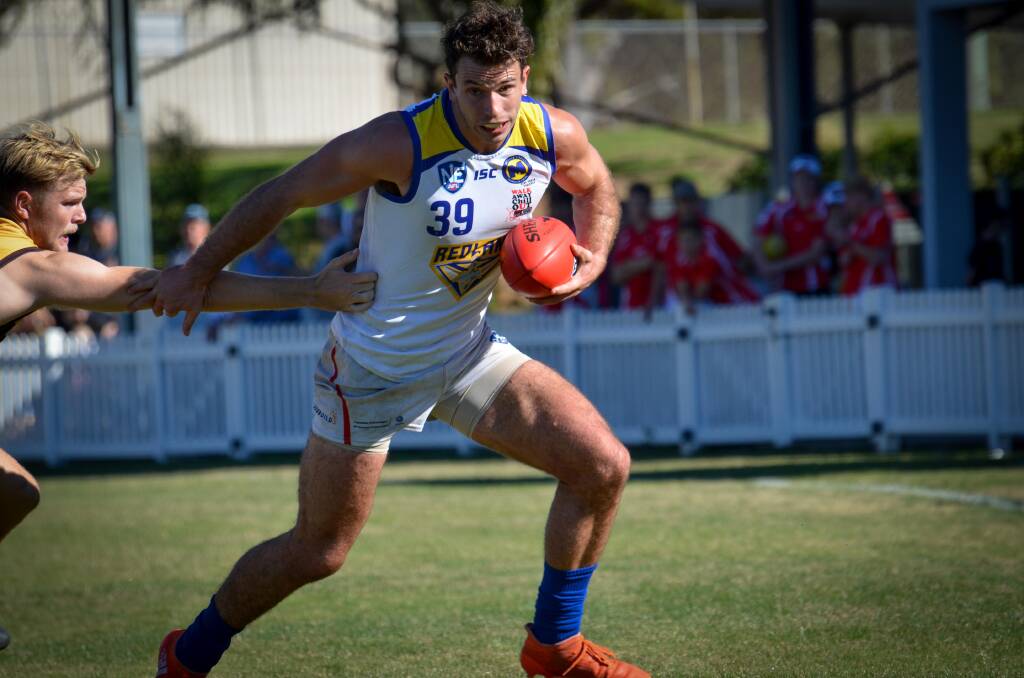 On the move: Strong running Bombers player Jackson Paine fends off an Aspley defender in the strong win over the Hornets. Photo: Supplied.