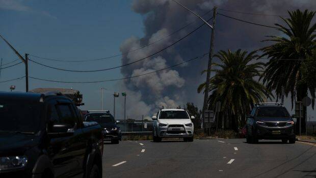 The fire at the Royal National Park viewed from Captain Cook Bridge on Saturday. Photo: Brook Mitchell