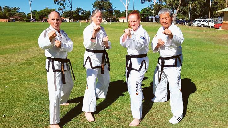 KICK ARTS: Ian Green, Leanne Searle, Pat McQueen and Patrick Ng suited up for taekwon-do. Photo: Low Taekwon-Do Academy