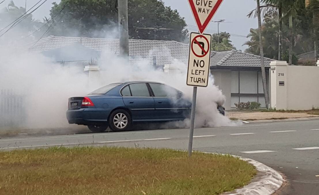 Smoke engulfs a Holden Commodore in Vienna Road. Photo: Matt Goode