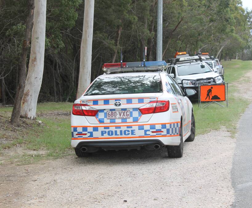 RESPONDING TO A COMPLAINT: Police and council vehicles park alongside bush land in Alexandra Hills while officers talk to a homeless man who lived there for an unknown length of time. Photo: Cheryl Goodenough