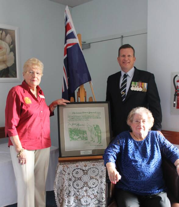 DONATION: Kath McNeilly from the Redland Museum, with councillor Paul Golle and Olivene Lagerroth. Photo: Cheryl Goodenough