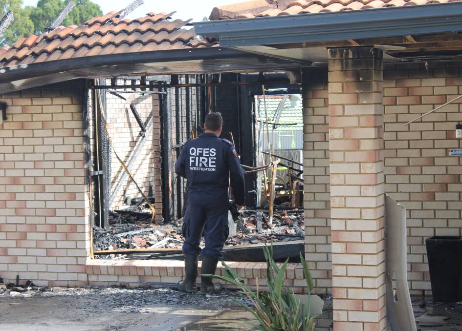 INVESTIGATION: A Queensland Fire and Emergency Services investigator at the scene of the house fire at Alexandra Hills earlier this year. Photo: Cheryl Goodenough