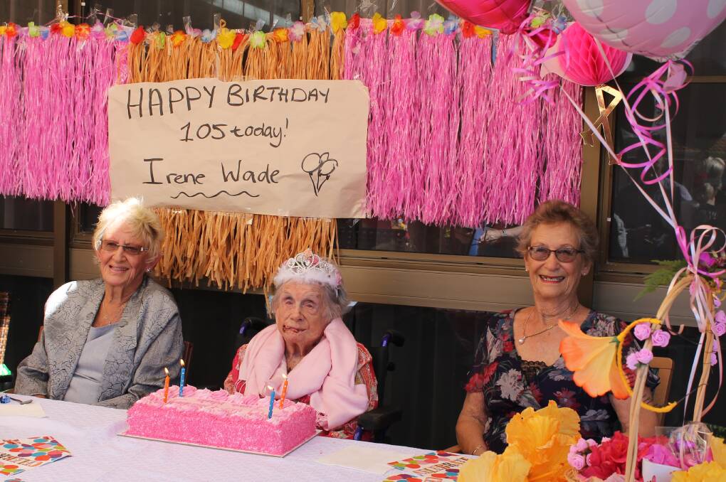 ISLAND LIFE: Irene Wade (middle) with her daughters Pamela Sibly and Beverley Brecknell at her Hawaiian-themed 105th birthday at Nandeebie Centre of Care, Alexandra Hills. Photo: Cheryl Goodenough