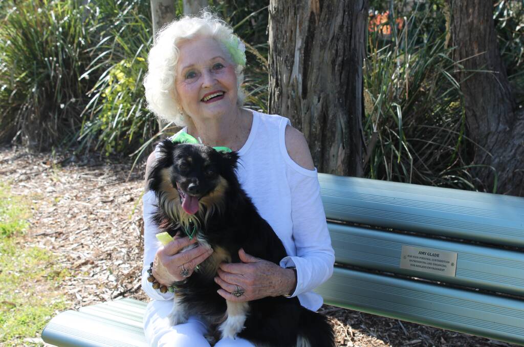 TRIBUTE: Amy Glade and her dog on the tribute bench that has been put up in a Capalaba park. Photo: Cheryl Goodenough