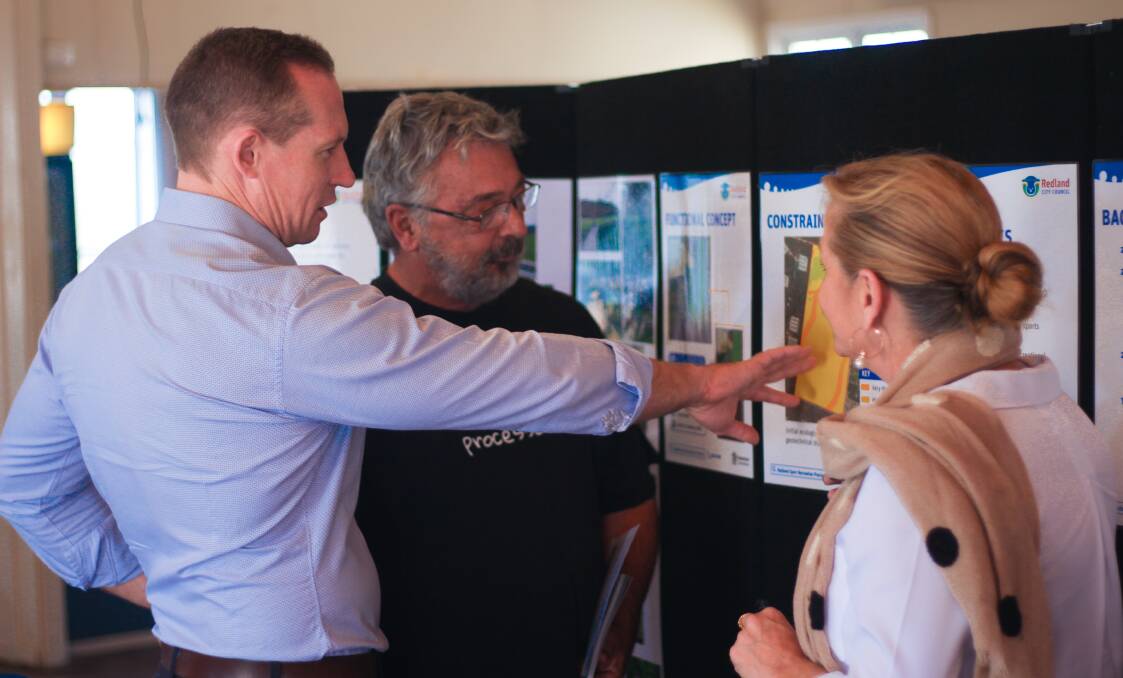 AT MOUNT COTTON: Springwood MP Mick de Brenni and Redland City mayor Karen Williams speak to a community member at the Mount Cotton fire preparedness and information meeting on Sunday.