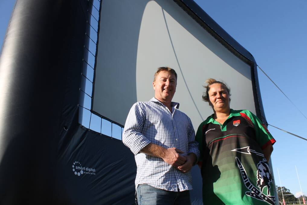 TRIAL: Cr Paul Gleeson and Capalaba Warriors events co-ordinator Tanya Bonney take a look at the 8 metre by 6 metre outdoor movie screen which will make its debut for the State of Origin match on Sunday.