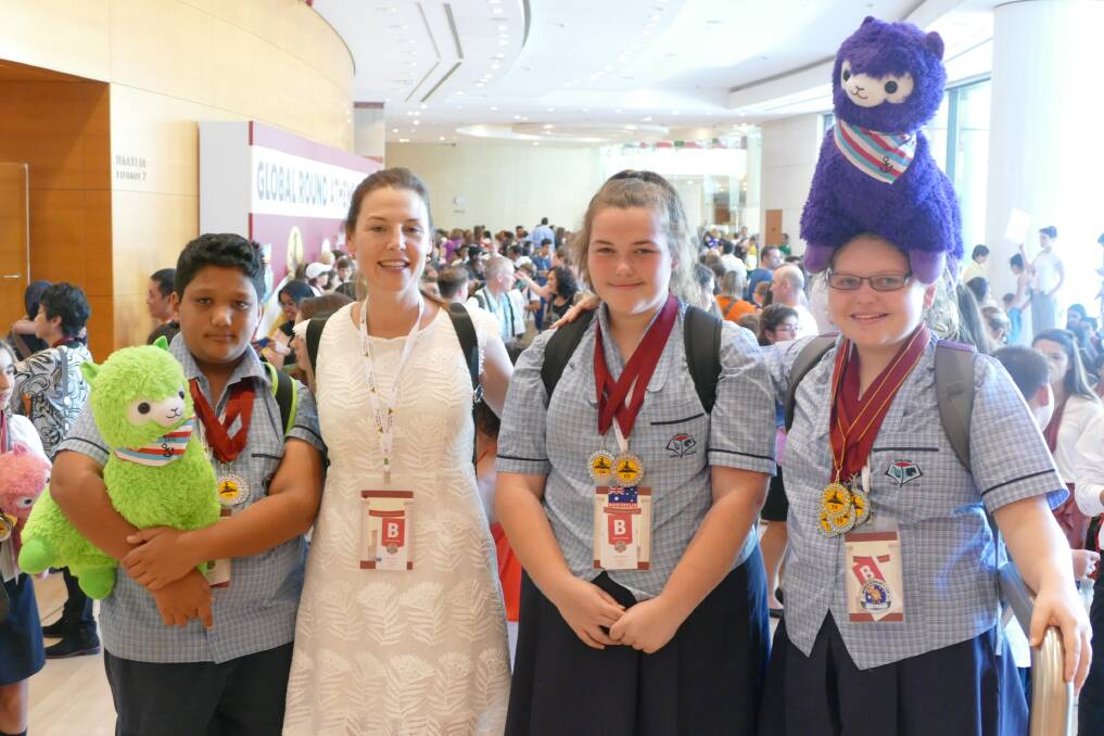 IN ATHENS: Capalaba State College principal Bronwyn Johnstone with students Tej Stewart-Ramji, Kaitlin Fuller and Ashleigh Walker holding the alpaca World Scholar's Cup mascots. Photo: Supplied