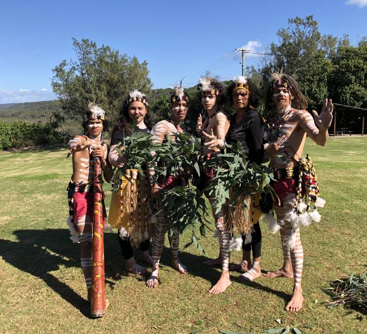 AHEAD OF THE BUILD: Quandamooka dancers perform a ceremony at Point Lookout ahead of the start of the building of the NBN service.