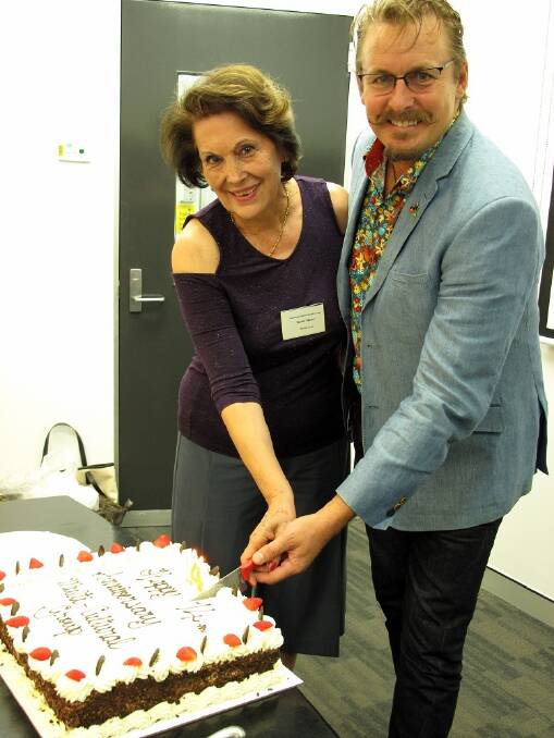 CAKE CUTTING: Redlands Multicultural Group founder Shahin Master cuts the cake with Cr Paul Bishop. Photo: John Yanni
