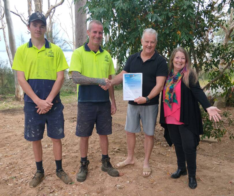 RECIPIENTS: The Macleay Island Quinn Plumbing team, with Macleay Island Arts Complex president Craig Shanks and artist Jan de Rooy.