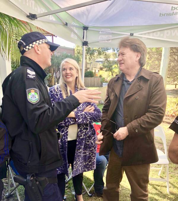 ON COOCHIE: Redlands MP Kim Richards and deputy mayor Lance Hewlett talk to Senior Constable Brendon Winslow on Coochiemudlo Island.