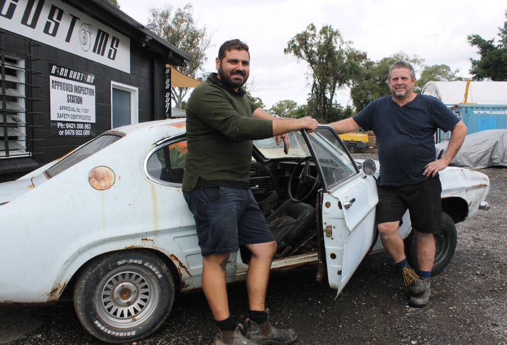 READY TO RESTORE: Boss Customs co-founders Adrian Aiple and John Wright with the car the young veterans will restore for drag racing events. Photo: Cheryl Goodenough