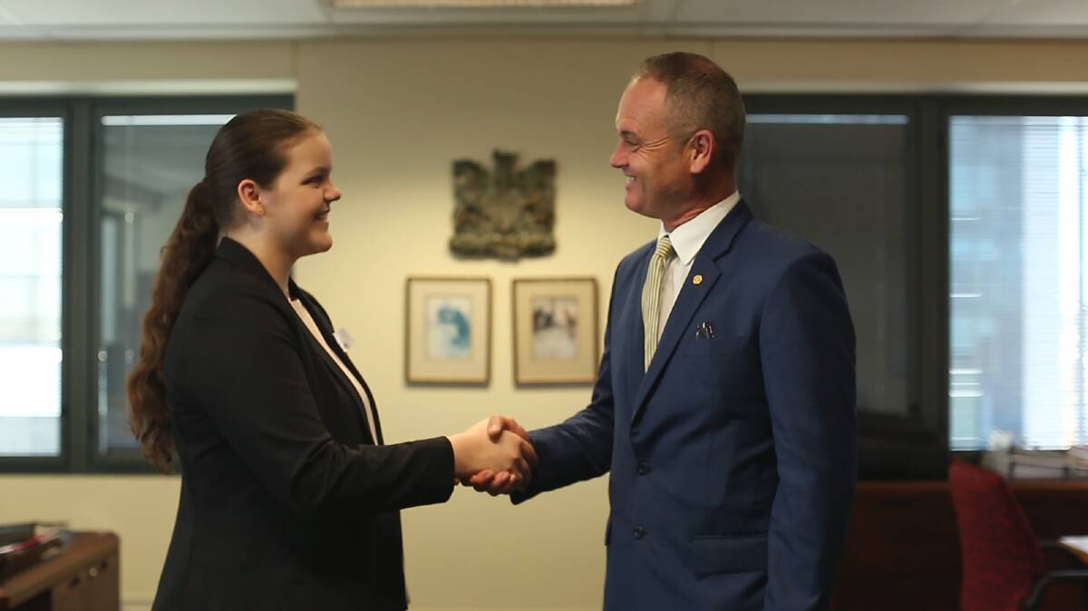 SHAKING ON IT: Grade 11 student Madison Birtchnell shakes hands with the head of the Queensland Justice Department David Mackie.