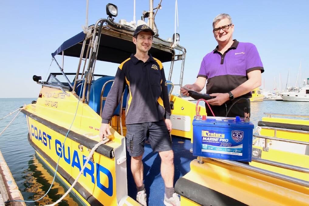 REMINDER: Coast Guard crewman John Tingey and Battery World's Steve Minter remind boaties to check their batteries ahead of the summer.