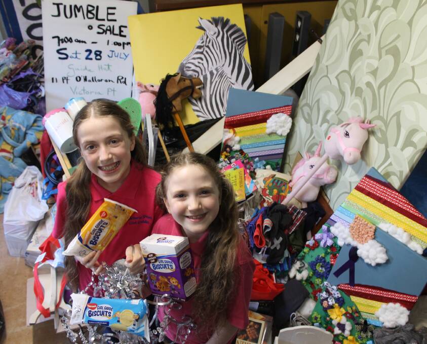 JUMBLE SALE: Girl Guide Lauder Briggs, 11, and Brownie Andrea Briggs, 8, prepare donated items for the jumble sale on July 28. Photo: Cheryl Goodenough