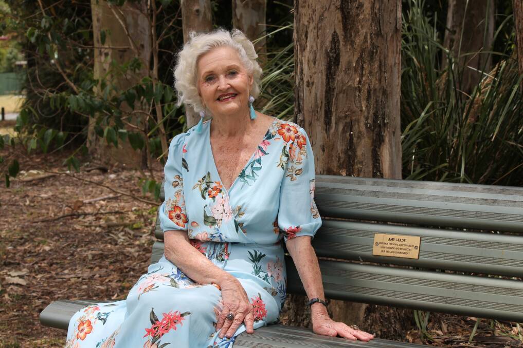 TRIBUTE: Amy Glade sits on the bench in a Elmhurst Street, Capalaba park which bears a plaque paying tribute to her community work.