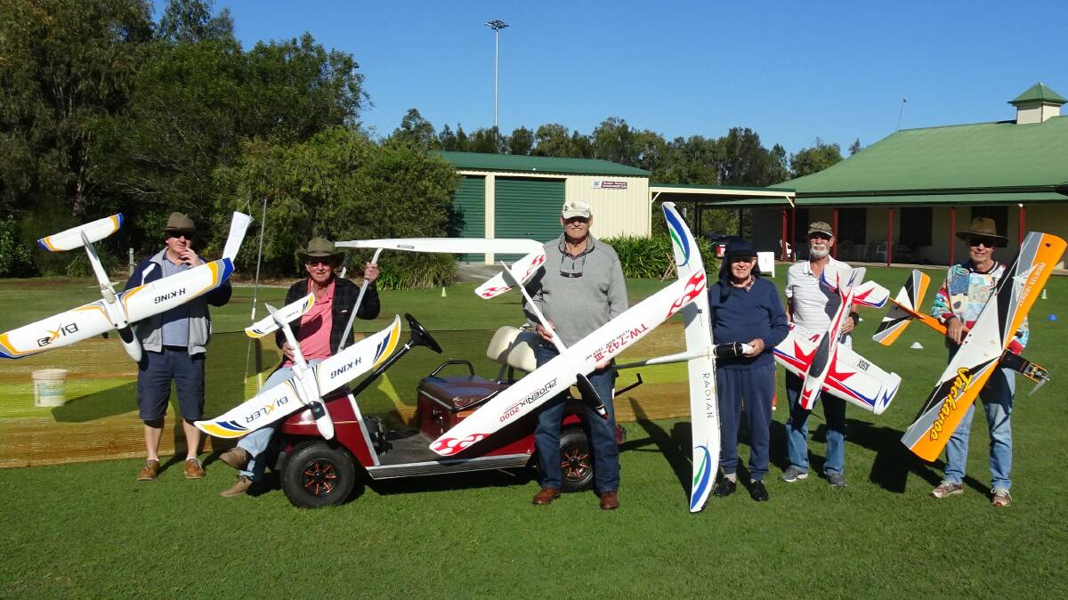 FLYING CLUB: Members of the Redland Aero Model Club stand with their model planes beside the cart they bought with a grant from Cr Paul Golle.